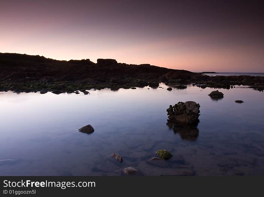 Beautiful ocean cove taken in Anna Bay, NSW, Australia during twilight conditions.