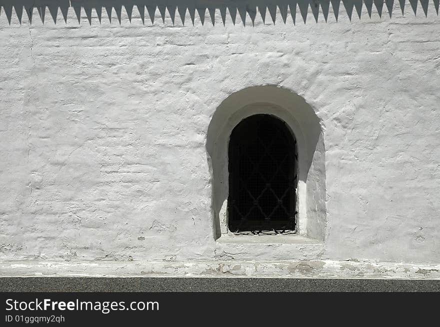 A window in a monastery wall. A window in a monastery wall