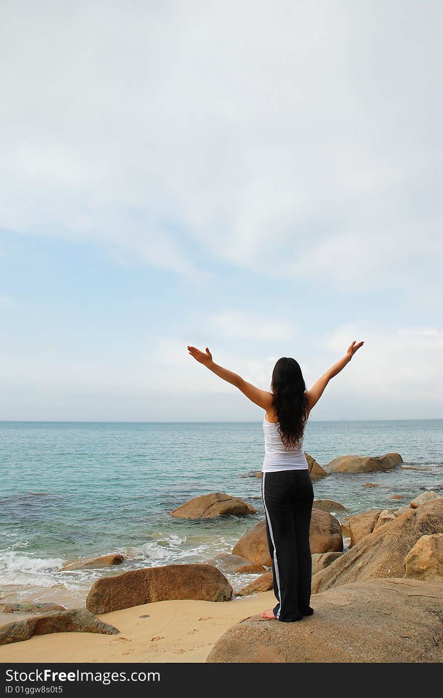 Young Woman Relaxing towards the Cloudy Sky