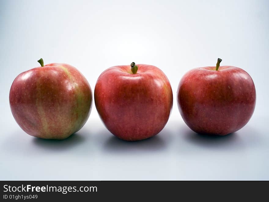 An image of three apples in a row.