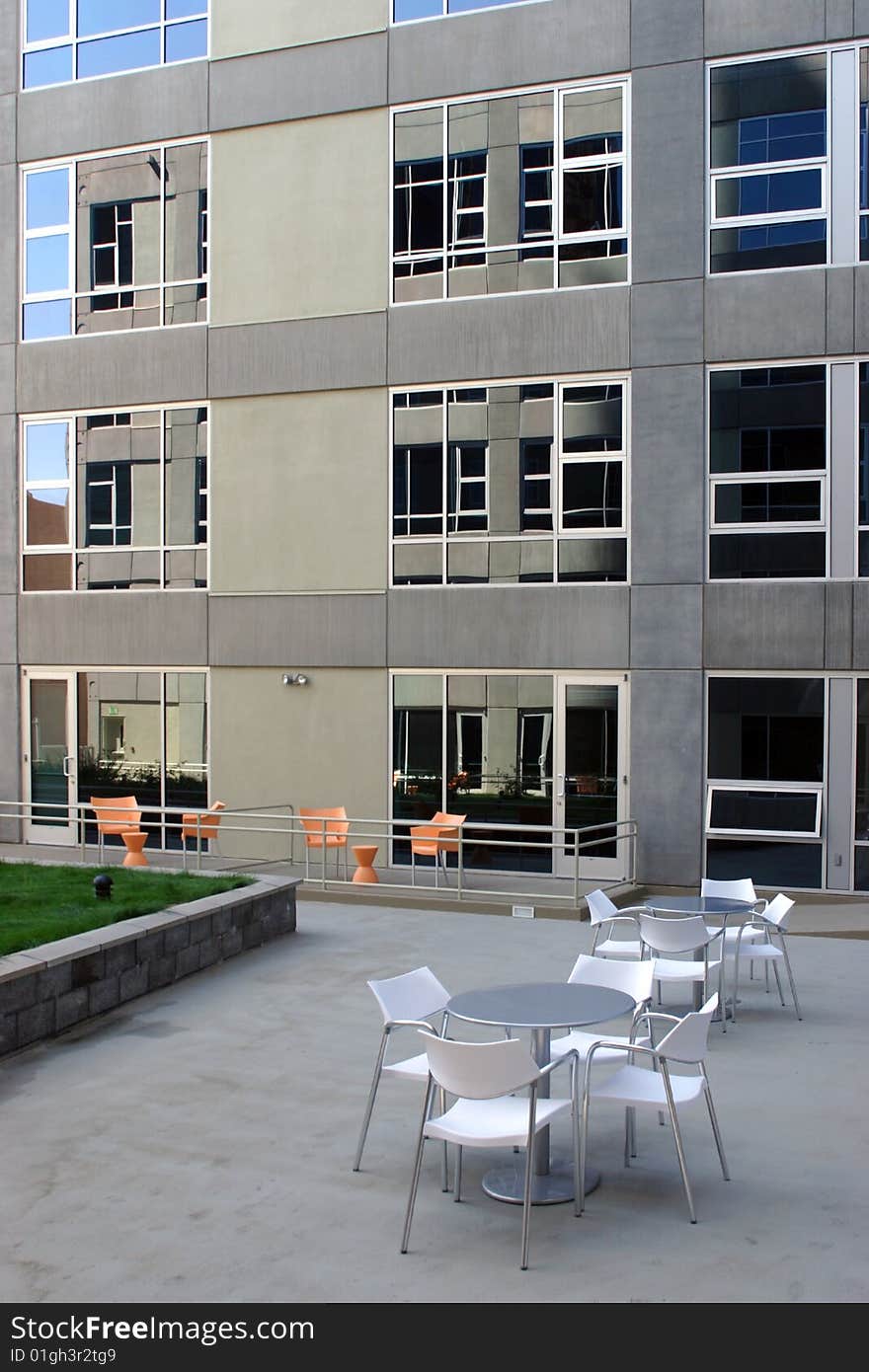 A modern loft courtyard with tables and chairs