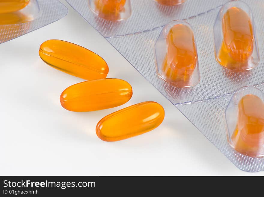 Yellow pills are photographed a close-up