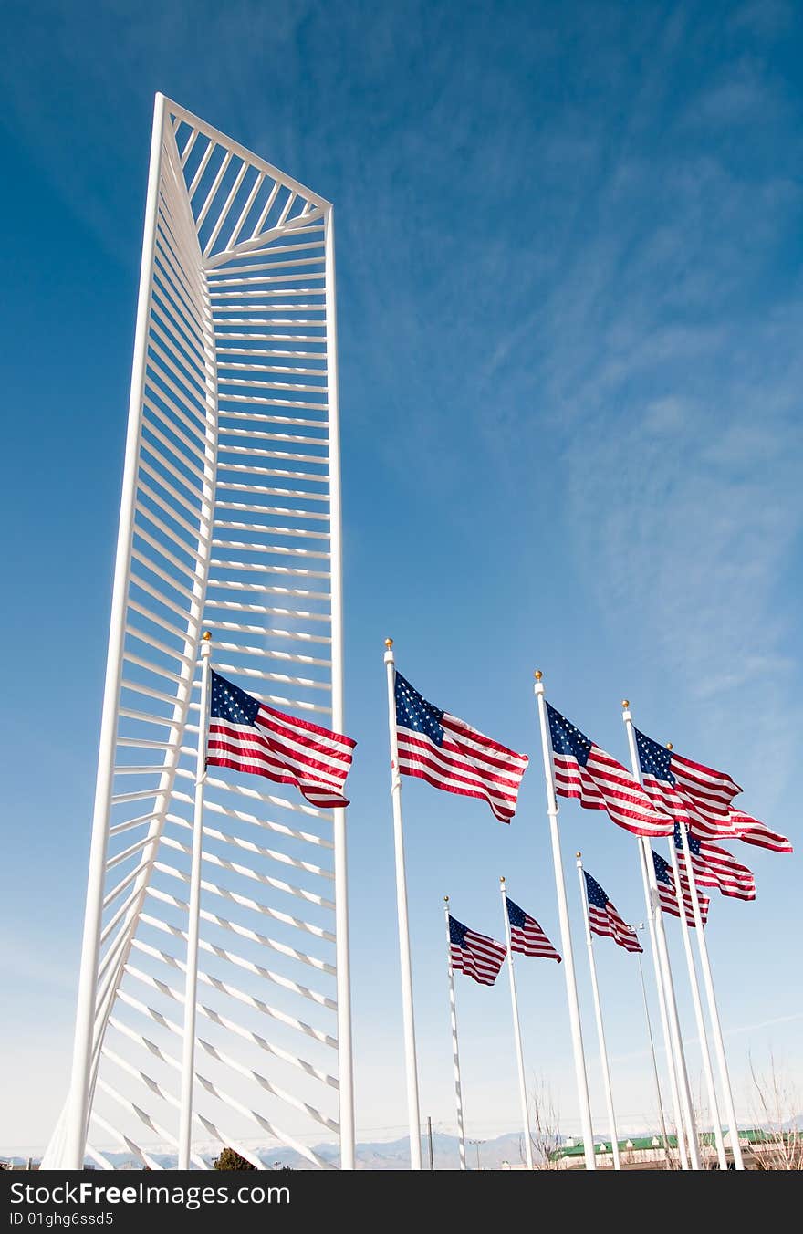 Two American flags frame a tall monument.