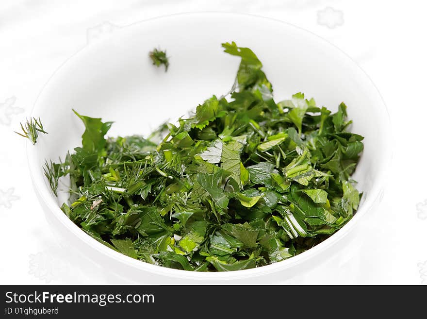 Green tops of parsley on white background