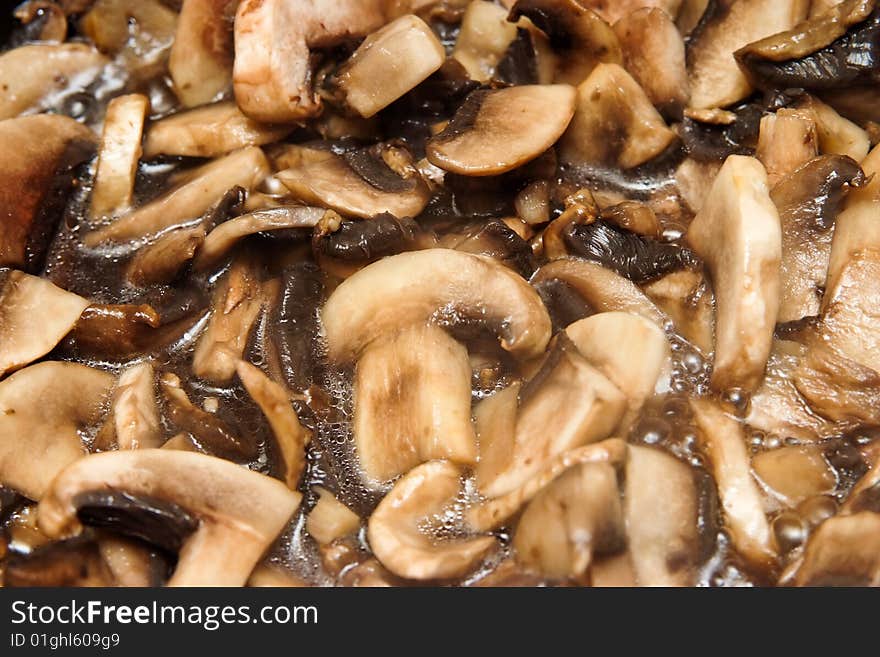 Slices of mushrooms roasting in pan. Slices of mushrooms roasting in pan