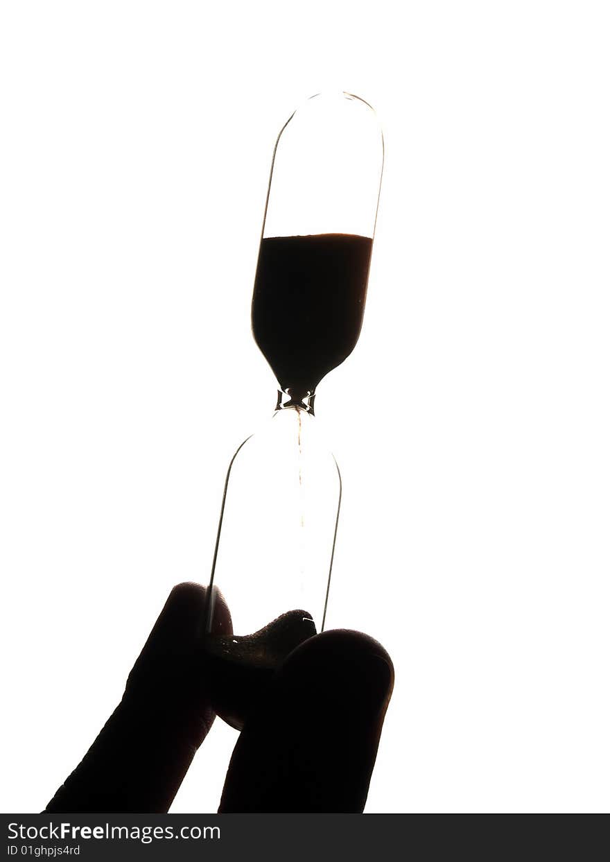 Retro hourglasses in hand backlit vertical isolated. Retro hourglasses in hand backlit vertical isolated