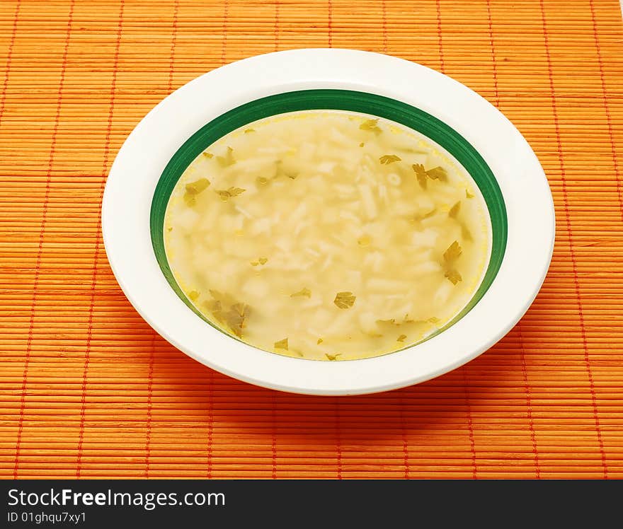 Soup in a plate on bamboo mat