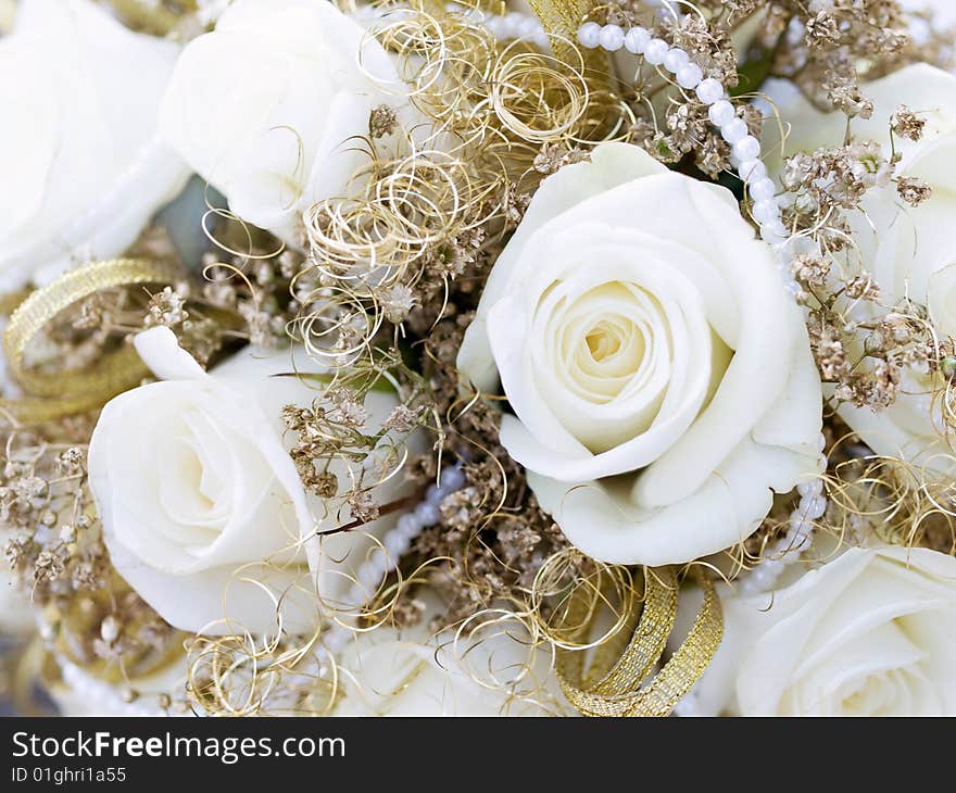 Close-up of roses and laces from wedding bouquet