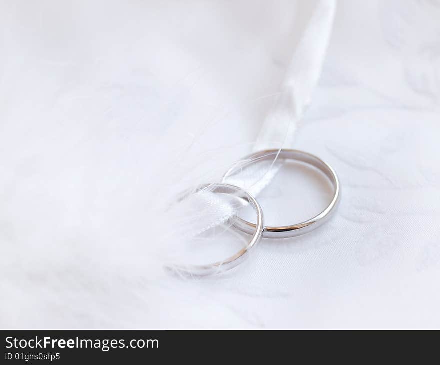 Closeup of wedding rings on a white textile