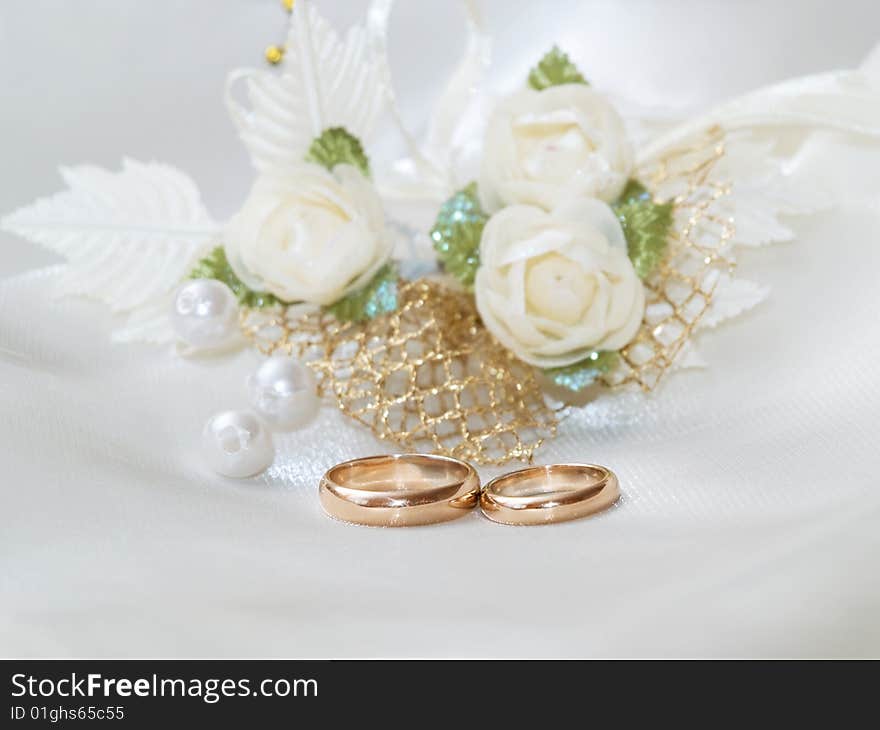 Closeup of wedding rings on a white textile