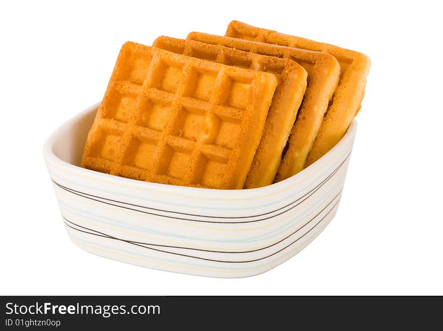 Four pieces of belgian waffles in plate isolated on white