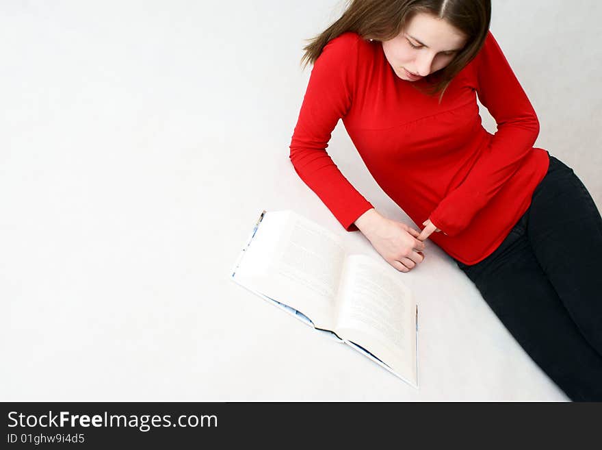 Young beautifful girl who read a book in isloated white background