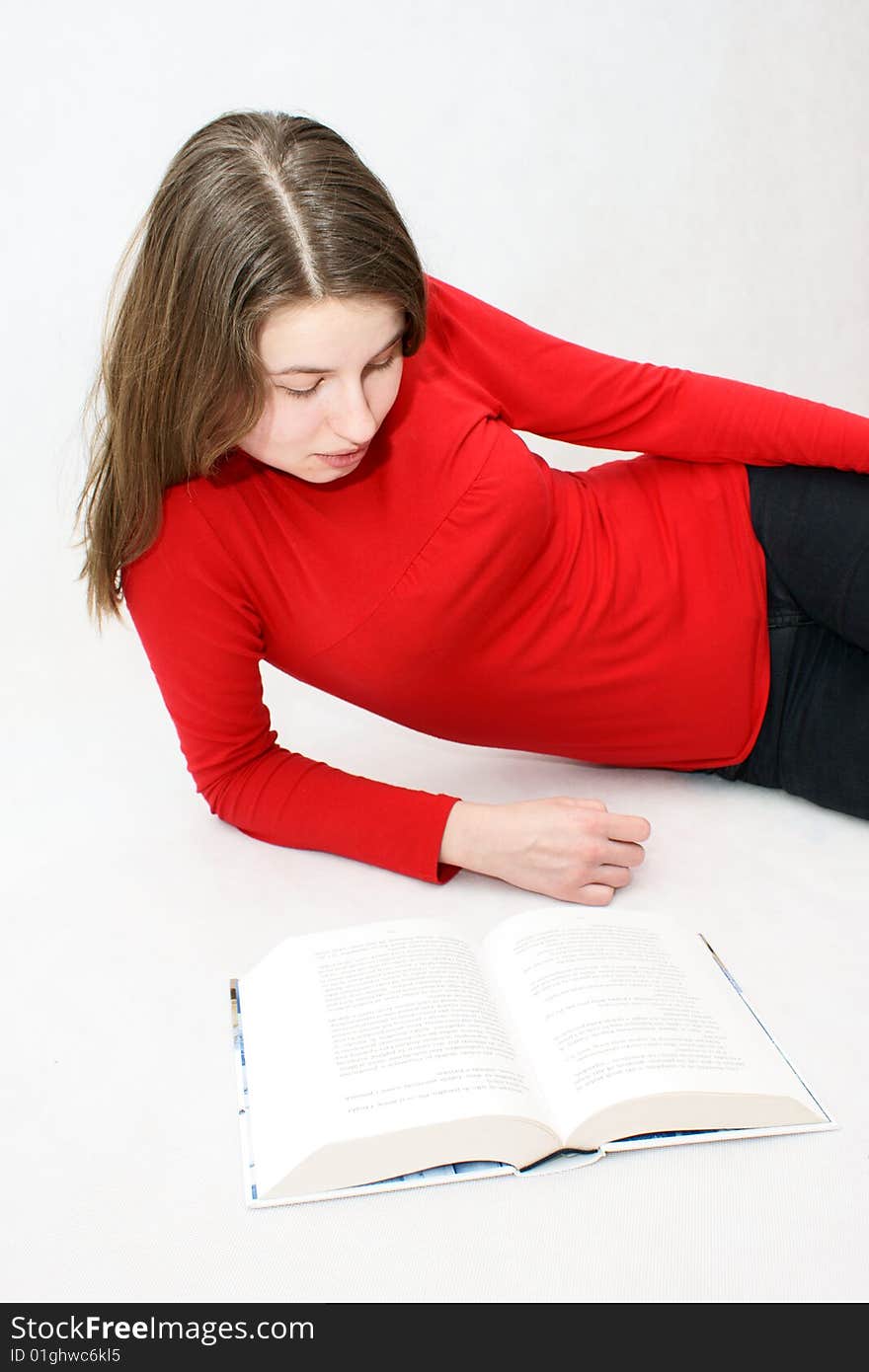 Young beautifful girl who read a book in isloated white background