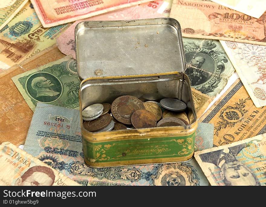 Old currency and metal box with old coins