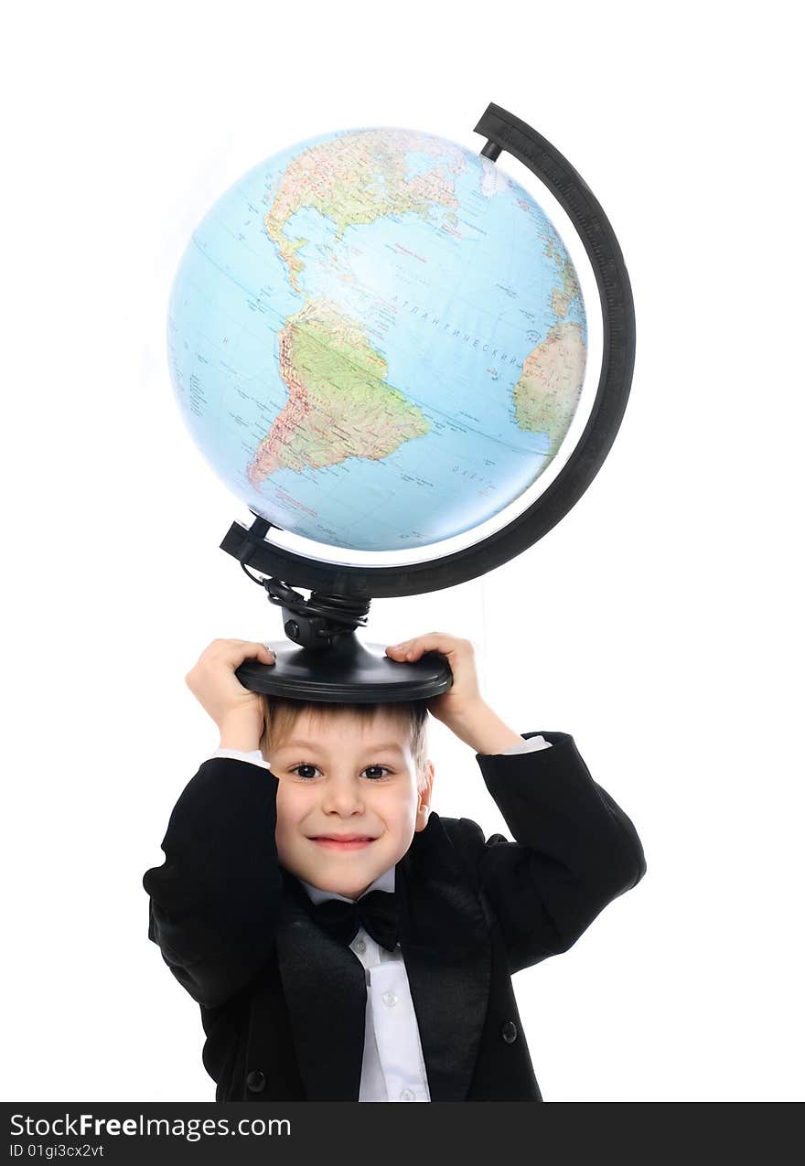 Happy little schoolboy holding a big globe on his head. Happy little schoolboy holding a big globe on his head