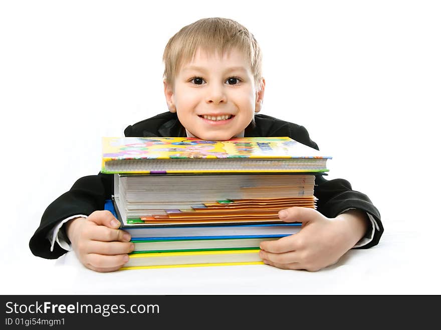 Happy schoolboy with books against white background