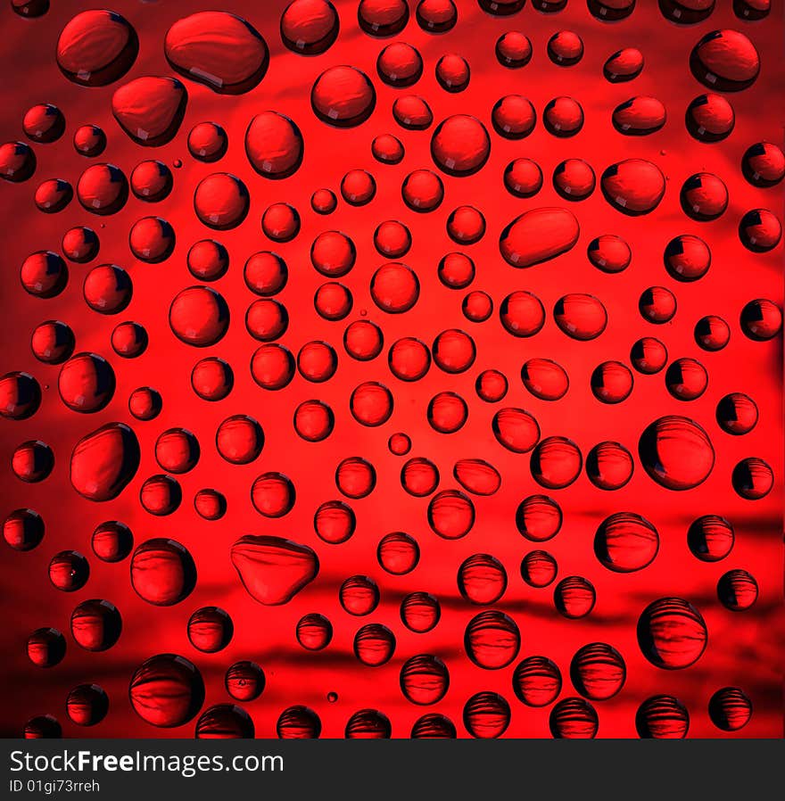 Coloured water drops on glass