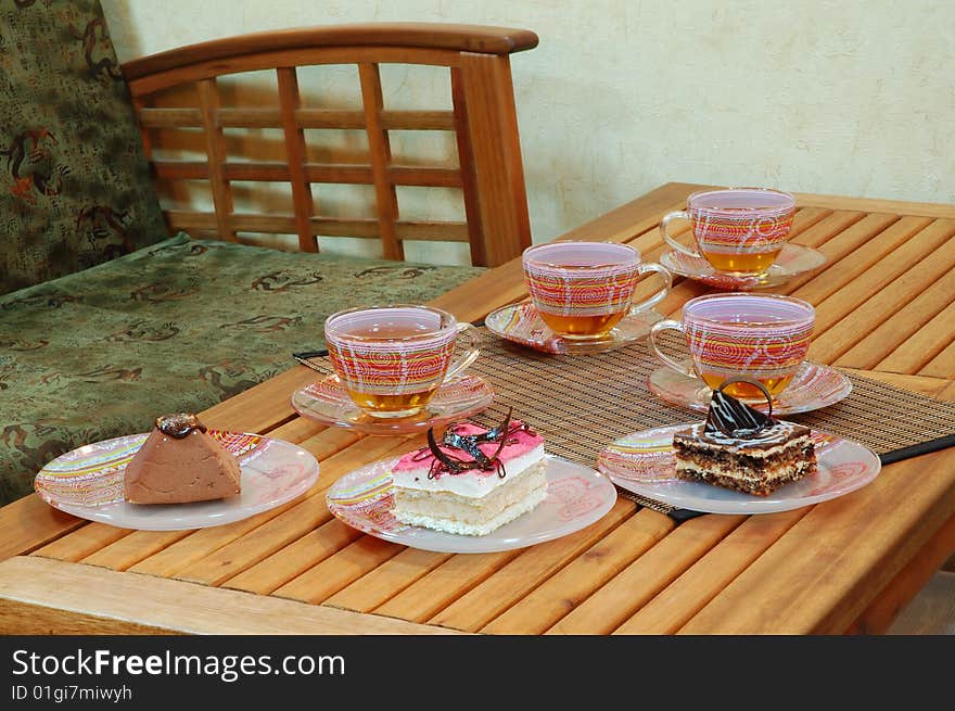 Various sweet cakes and cup of green tea on the table. Various sweet cakes and cup of green tea on the table