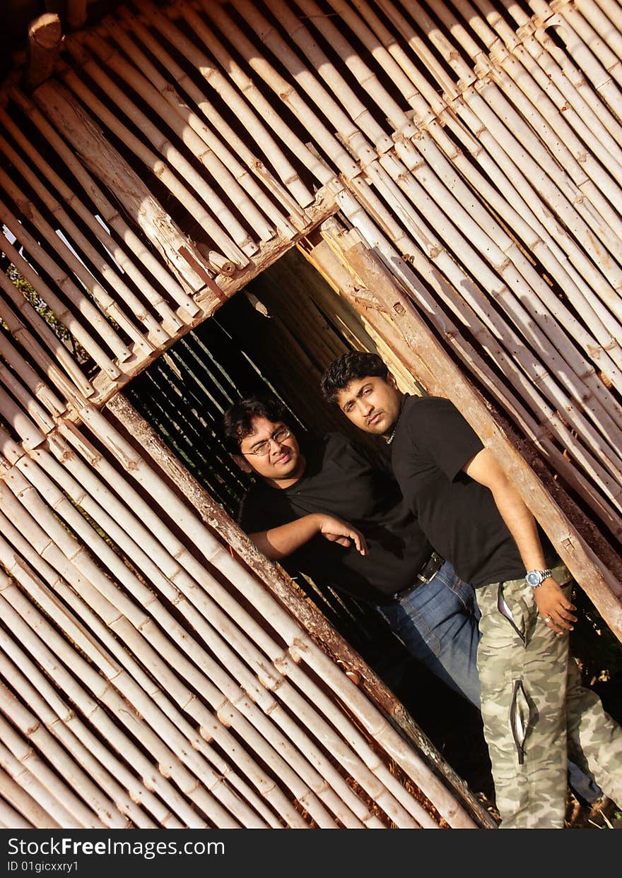 A couple of beast friends standing inside a bamboo hut, posing. A couple of beast friends standing inside a bamboo hut, posing