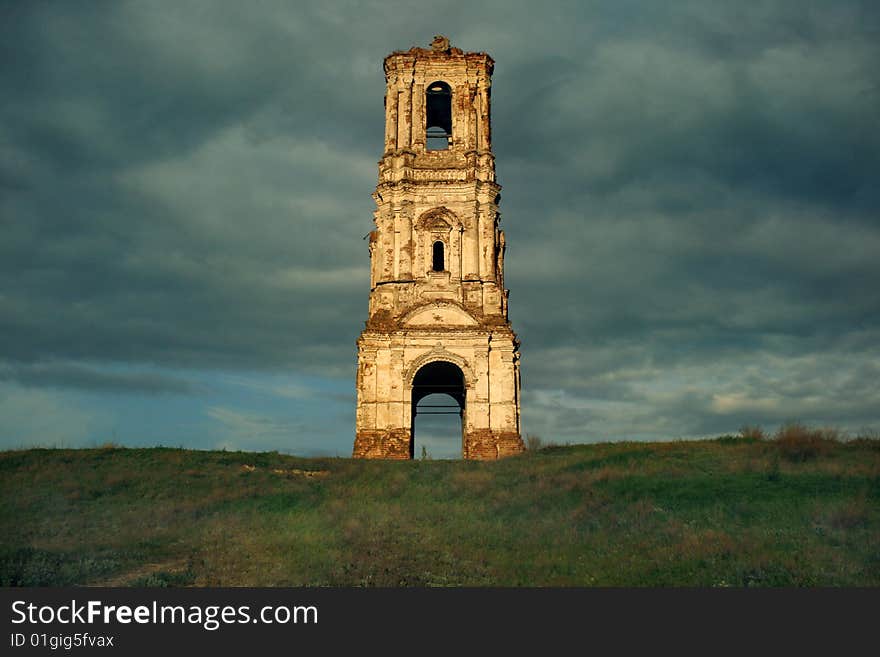 Russia. The Kachalino. The ruins of old belt-tower of the nineteenth century in dark blue sky. Russia. The Kachalino. The ruins of old belt-tower of the nineteenth century in dark blue sky.