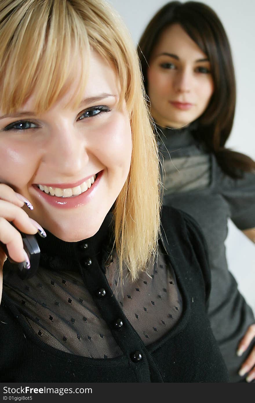 Businesswoman holding mobile phones. focus in on the front model.