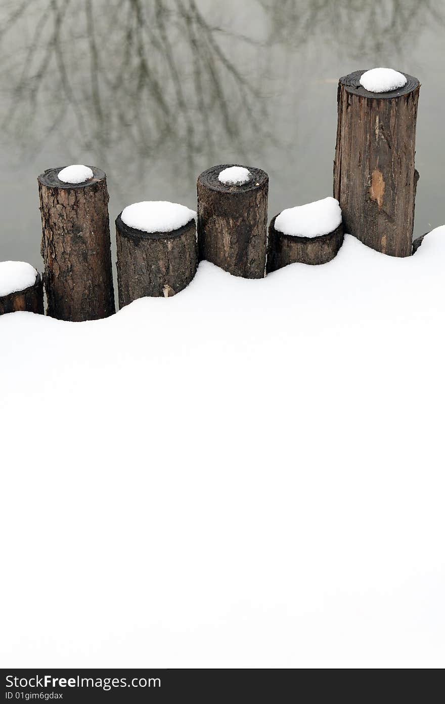 Shore wooden fence was covered with snow. Shore wooden fence was covered with snow.