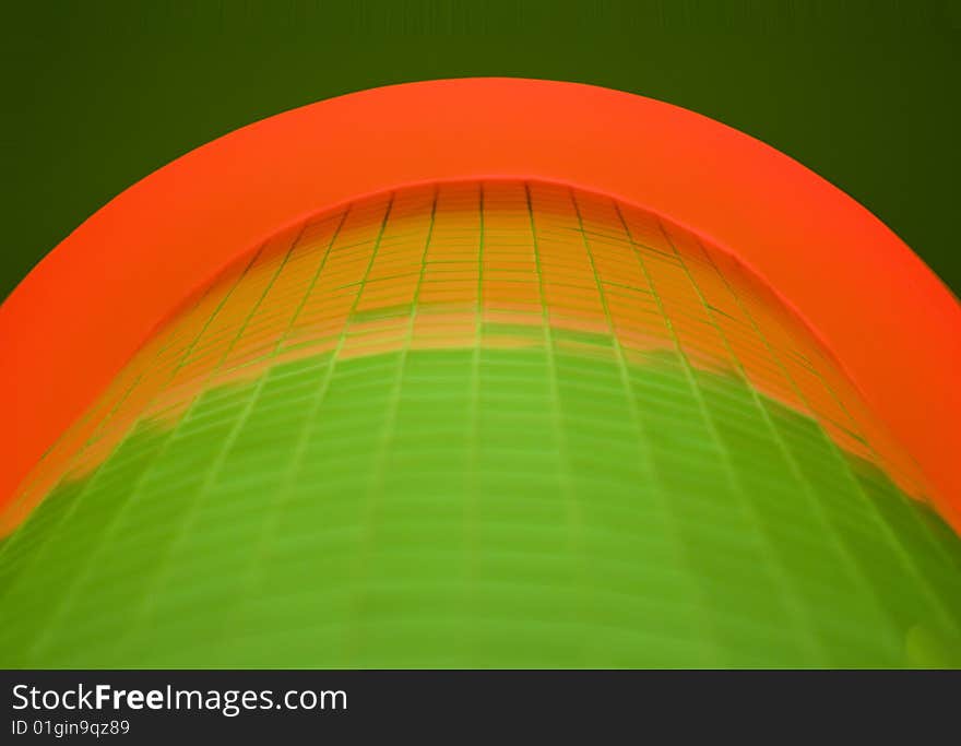 Abstract image of green tiles and red curve against a dark green background. Abstract image of green tiles and red curve against a dark green background