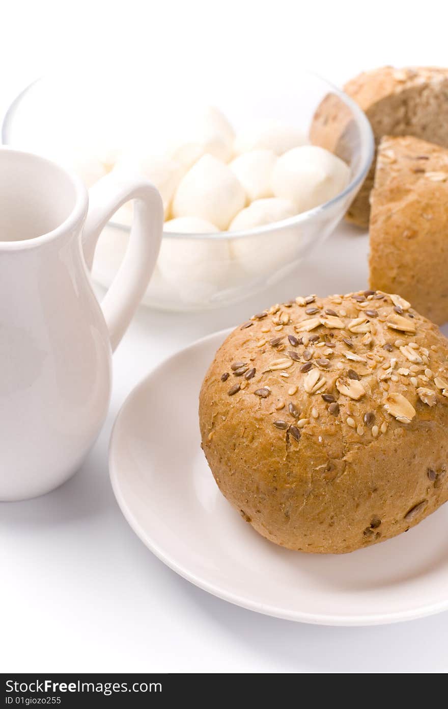 Bread, milk and mozzarella closeup on white