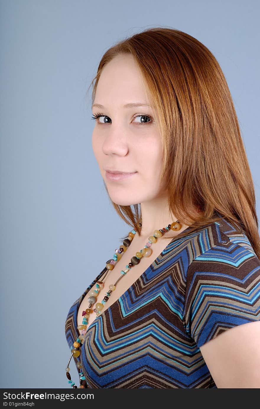 Portrait of a young beautiful woman on a blue background