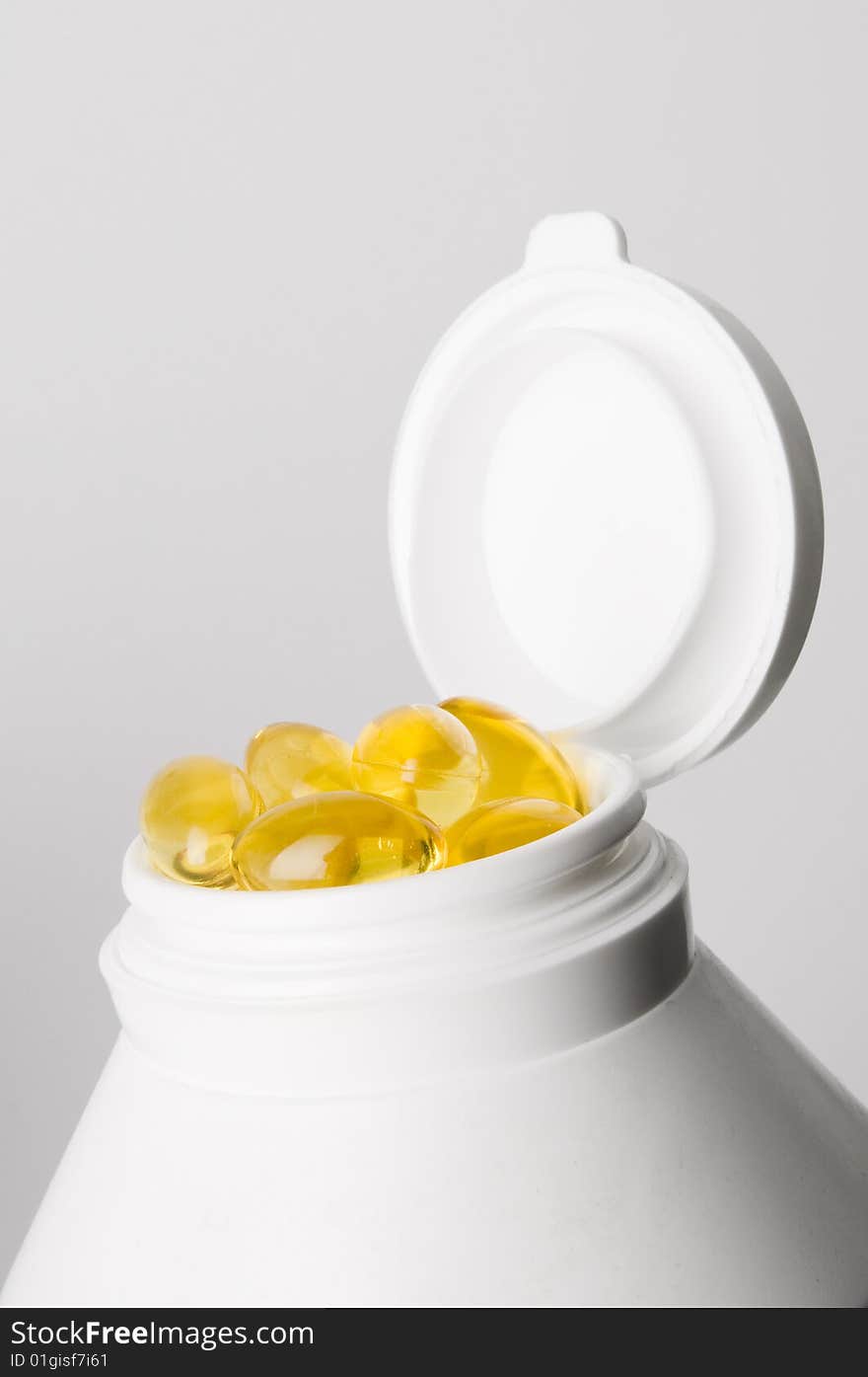 Medicine container with yellow pills