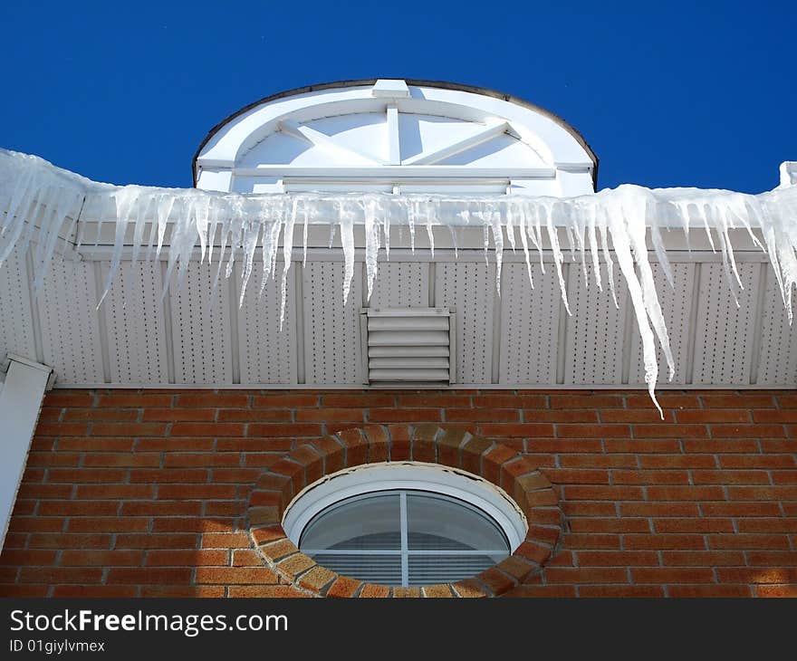 A house with icicles with a blue sky