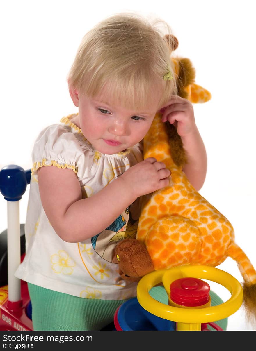 Child sits together with toy