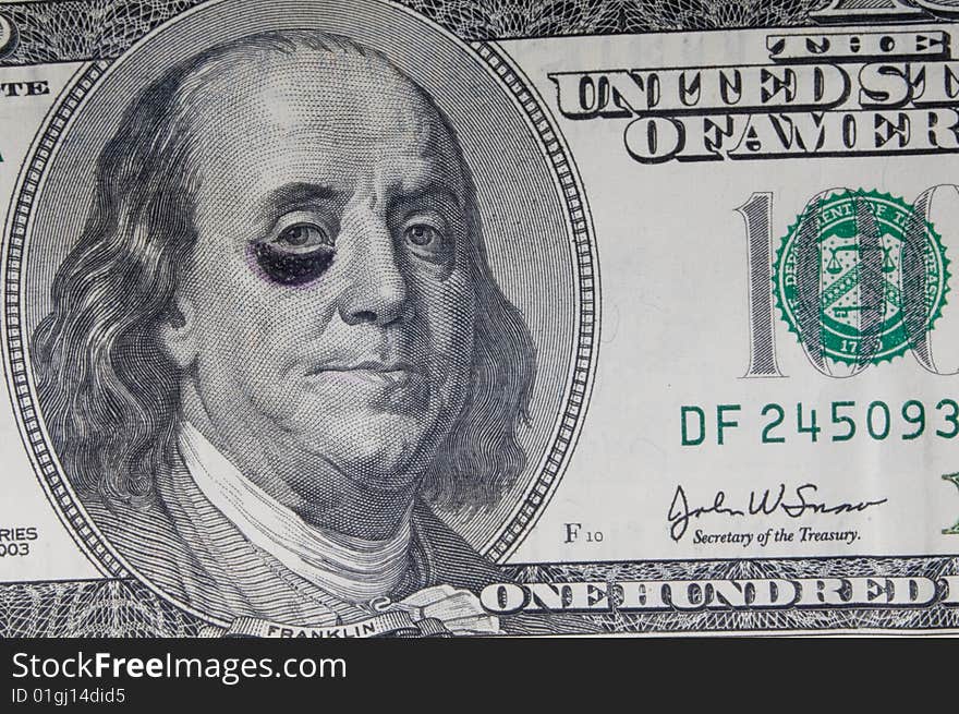 A shot of a hundred dollar bill with a black eye. A shot of a hundred dollar bill with a black eye.