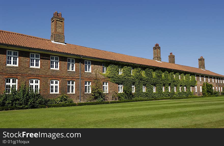 An old brick building in England covered with moss