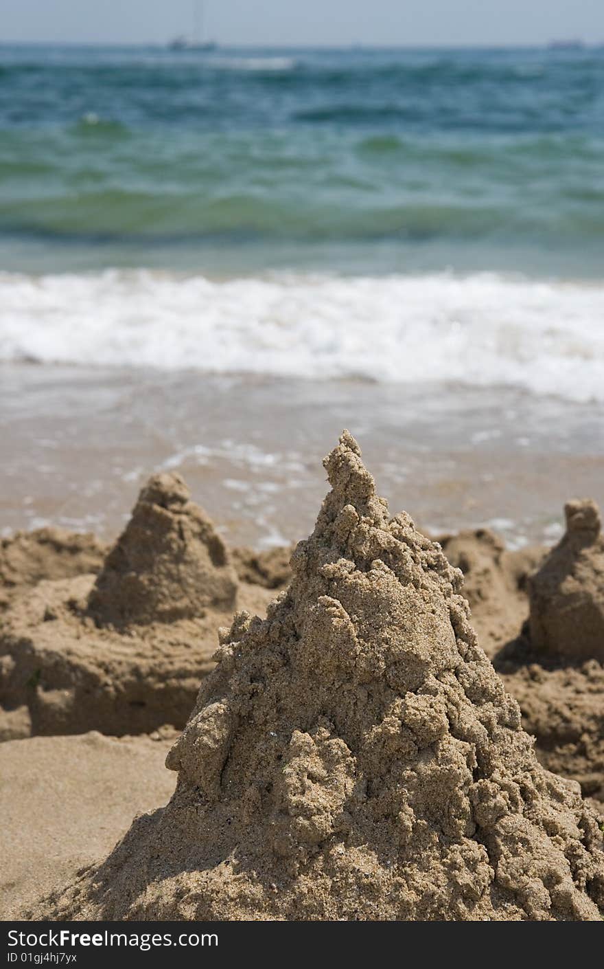 Sand castle aganist the sea. Sand castle aganist the sea