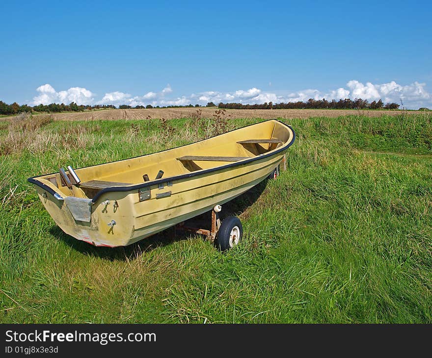 Small fishing Skiff boat on the seashore green field. Small fishing Skiff boat on the seashore green field