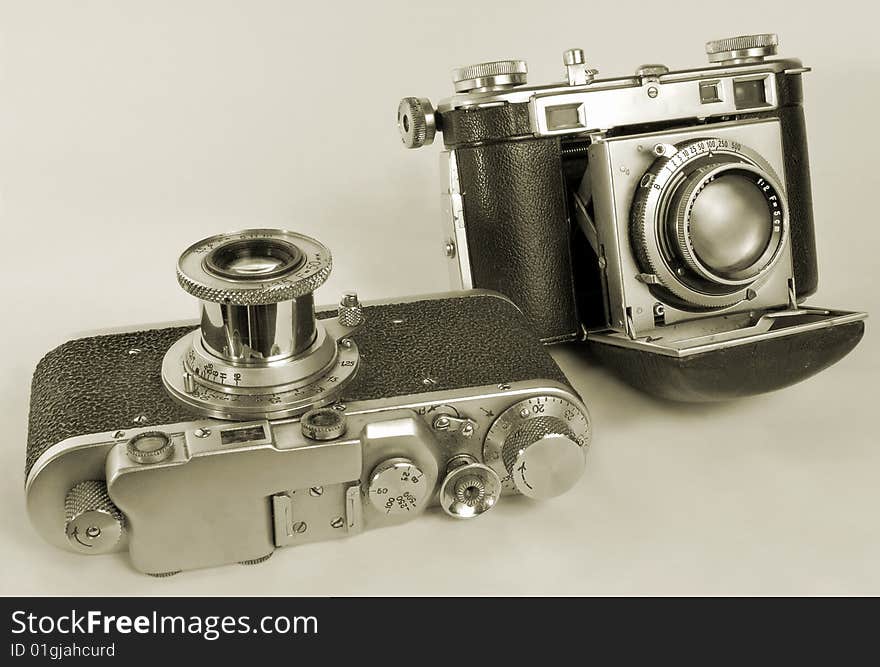 Two antiquarian 35-mm film cameras with put-forward lens. Two antiquarian 35-mm film cameras with put-forward lens.