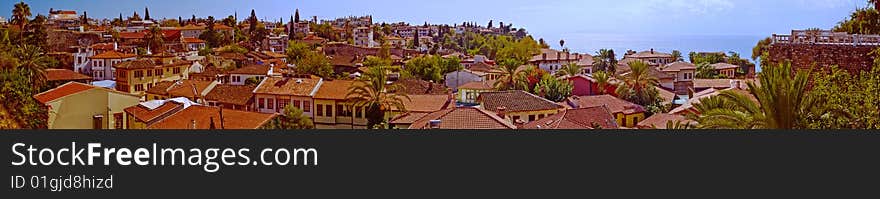 Panorama of beautiful Mediterranean city Antaliya house tiled roofs in clear summer weather. Panorama of beautiful Mediterranean city Antaliya house tiled roofs in clear summer weather