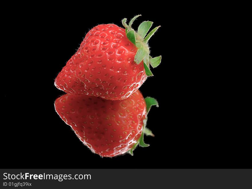 Strawberry isolated on black with reflection