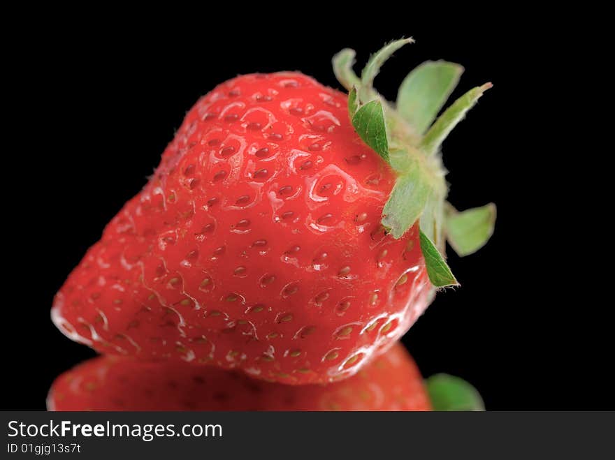 Strawberry isolated on black with reflection