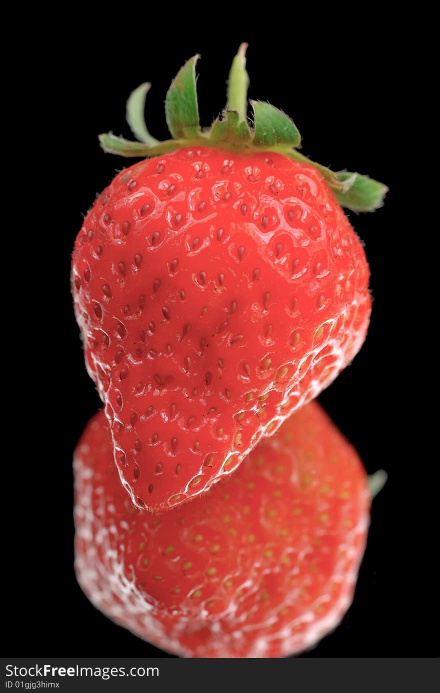 Strawberry isolated on black with reflection