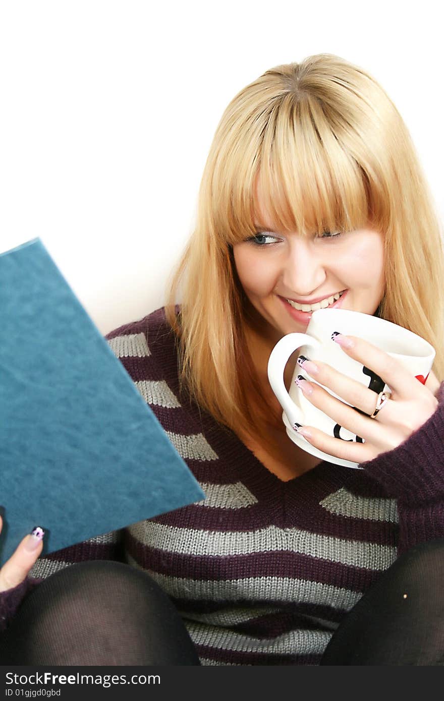 Portrait of a  young lady reading book with  cup in hand. Portrait of a  young lady reading book with  cup in hand