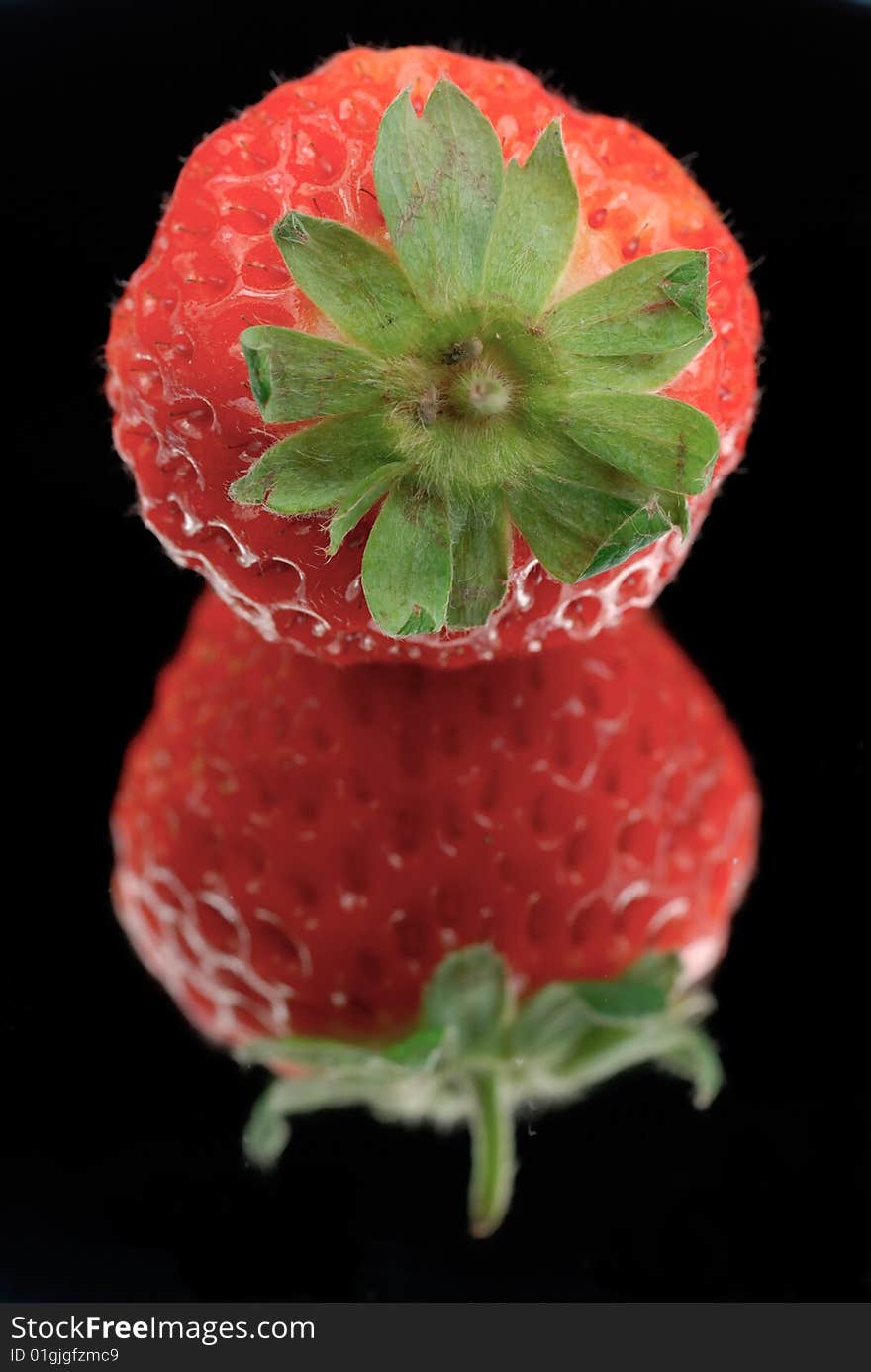 Strawberry isolated on black with reflection