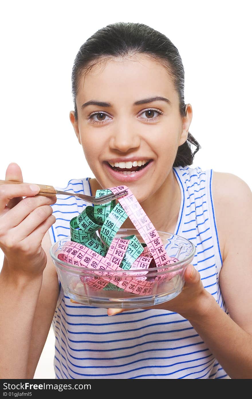 Portrait of a young woman eating measuring tape with a fork. Portrait of a young woman eating measuring tape with a fork