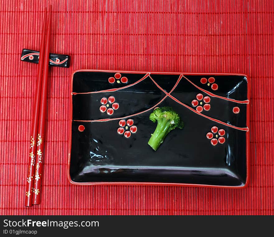 Set of black chinese ceramics kitchen utensils and broccoli