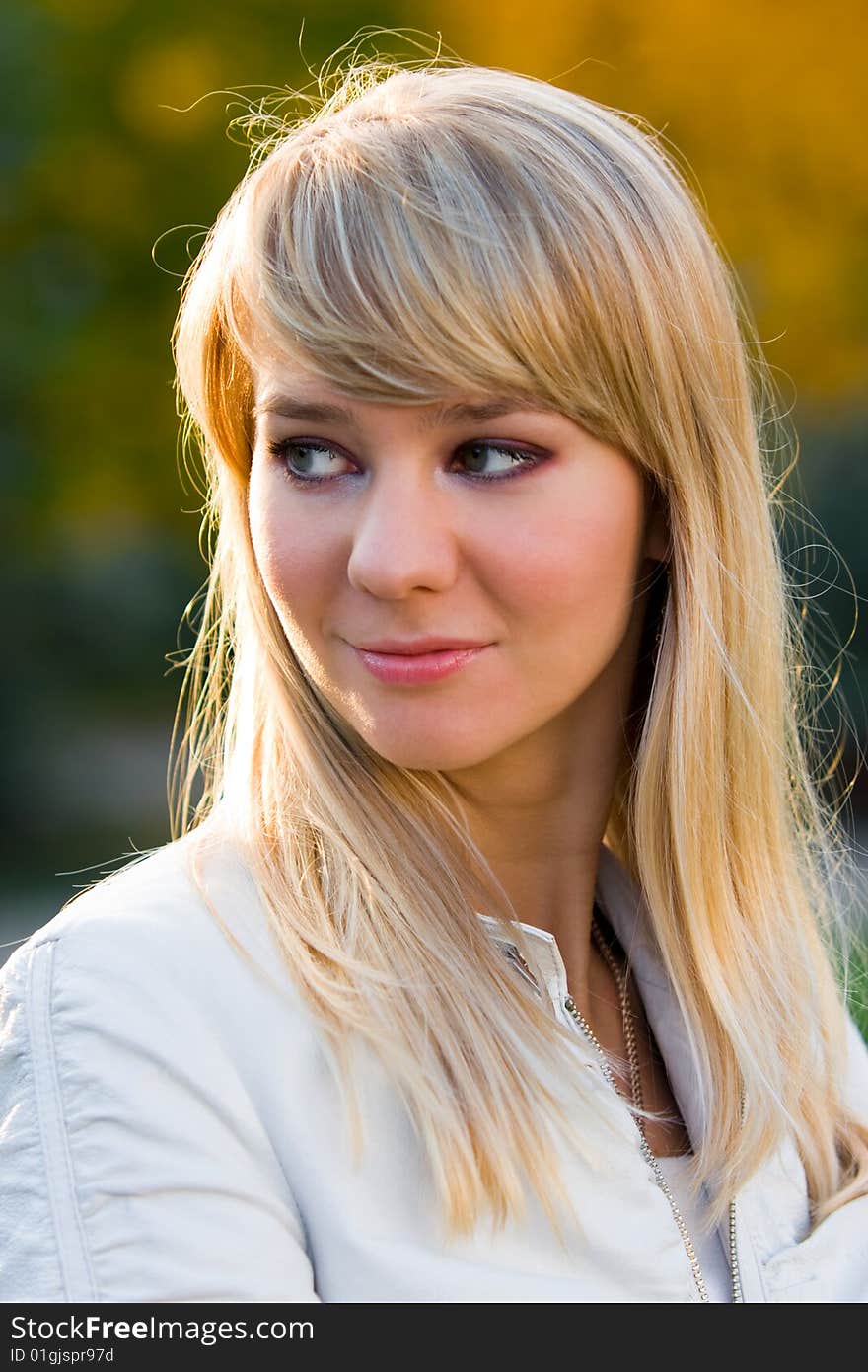 Pretty girl - face portrait on autumn yellow-green background - shallow DOF