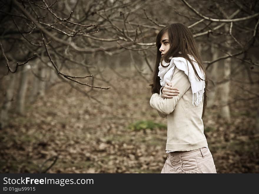 Young pensive woman in dark scenery. Young pensive woman in dark scenery.