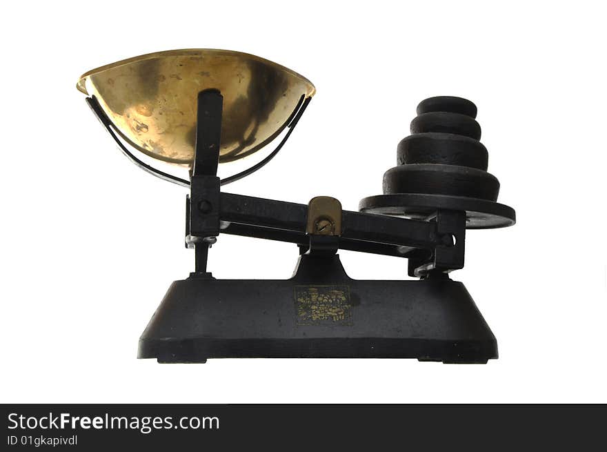 Old fashioned cast iron kitchen scale with brass pan and black metal weights. Old fashioned cast iron kitchen scale with brass pan and black metal weights