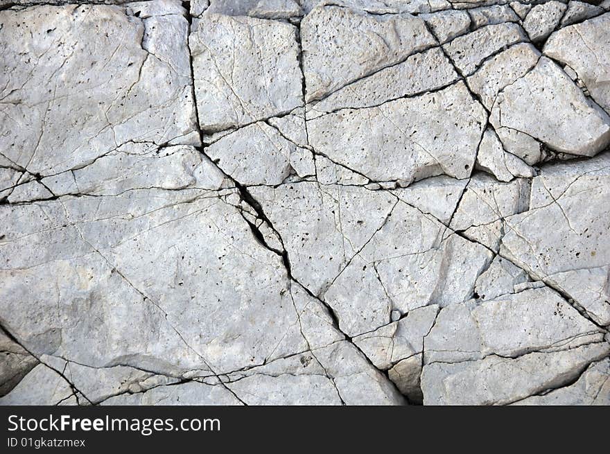 Cracked hard stone as background