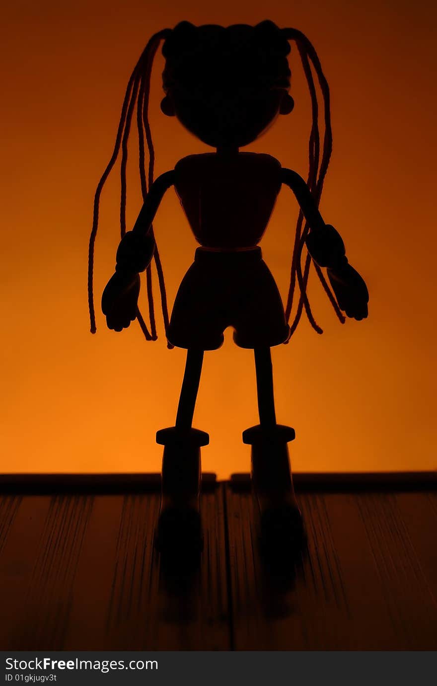 The dark image of a home-made doll